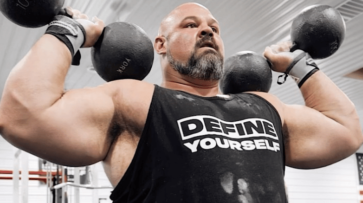Brian Shaw with two circular dumbbells in hand
