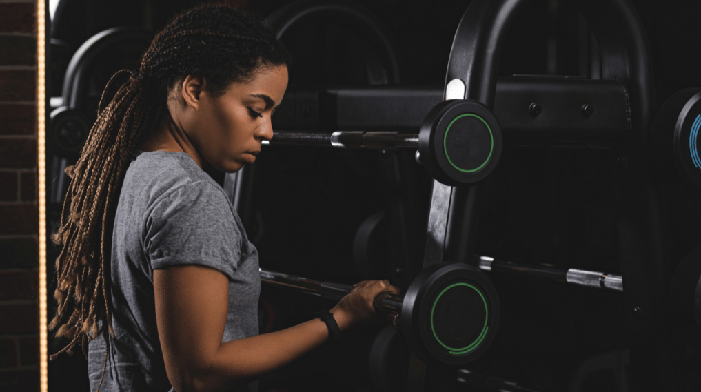 Athlete perusing a small barbell