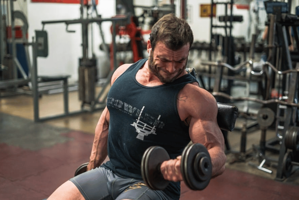 Man performs seated biceps curl