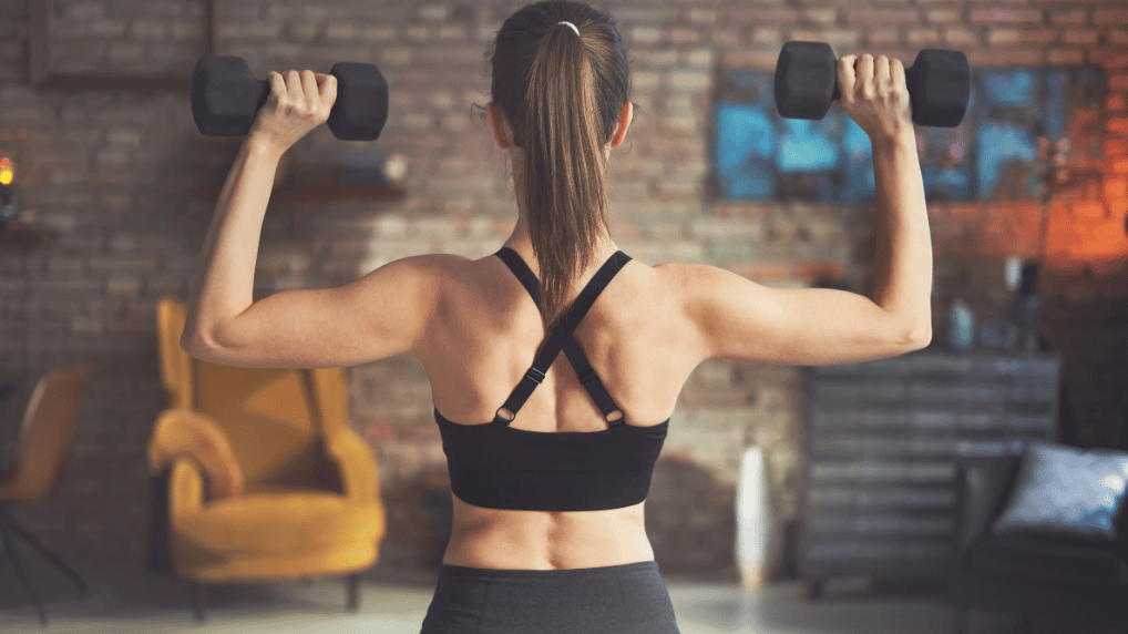 Image: An athlete holds two dumbbells