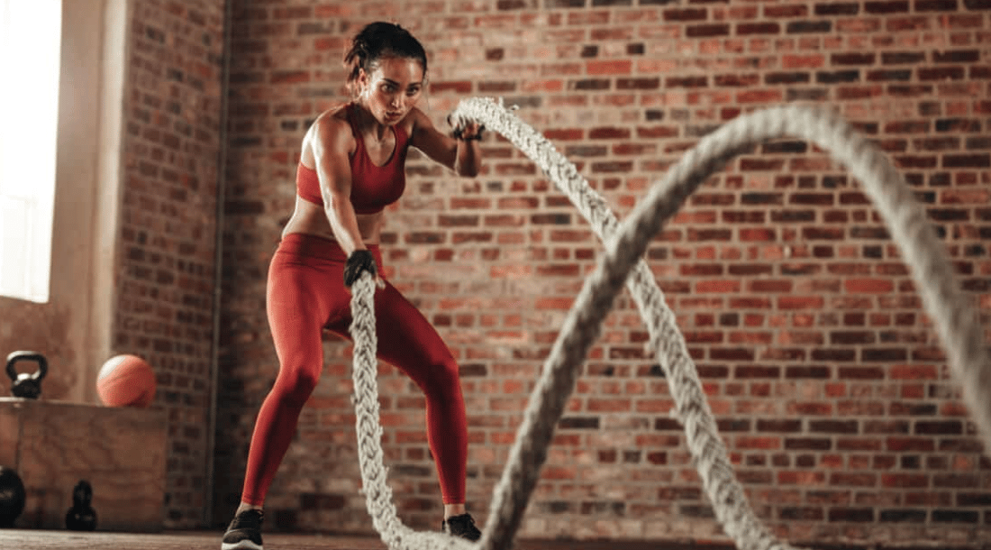 Athlete performs a battle rope movement