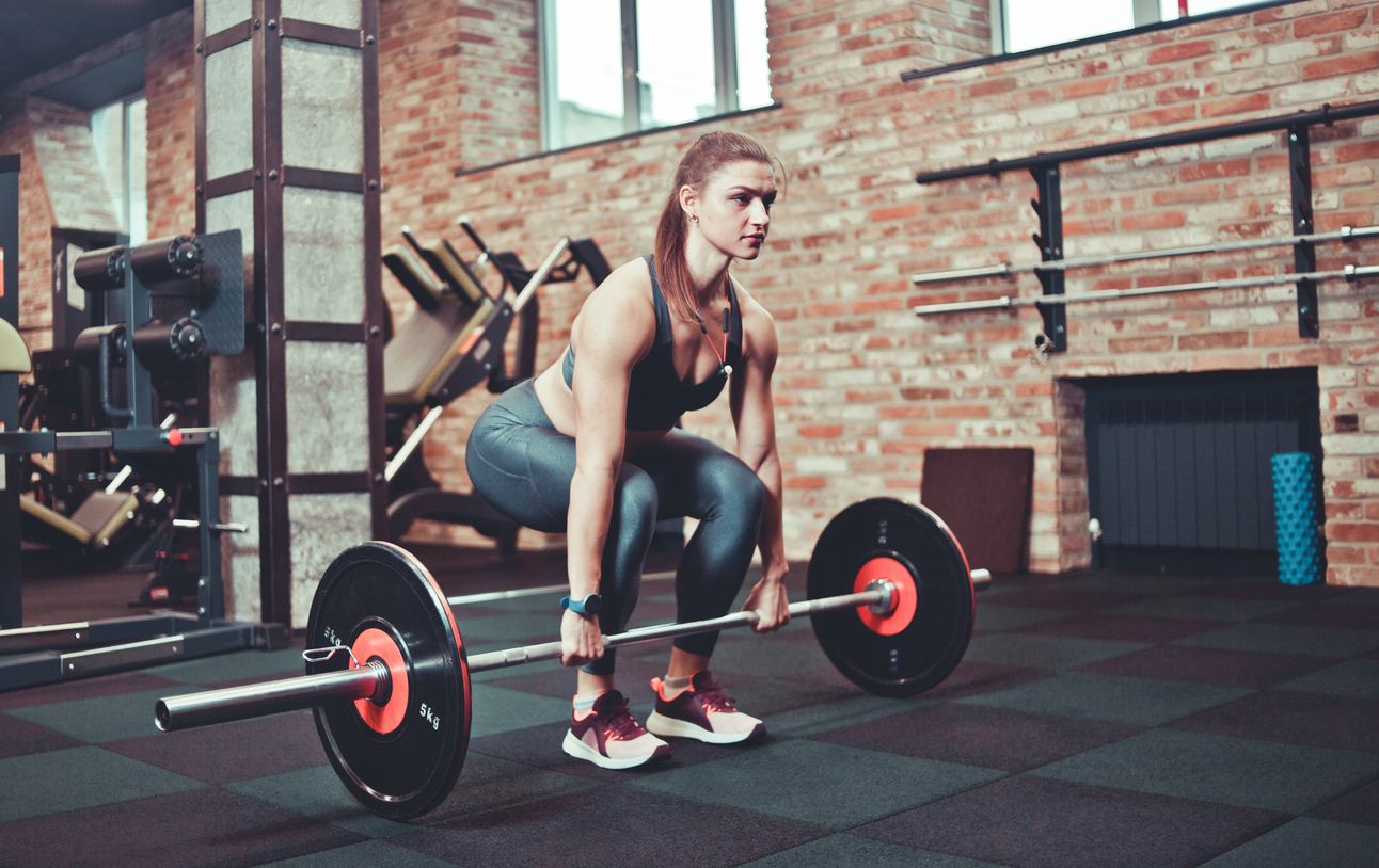 Woman prepares to perform a deadlift