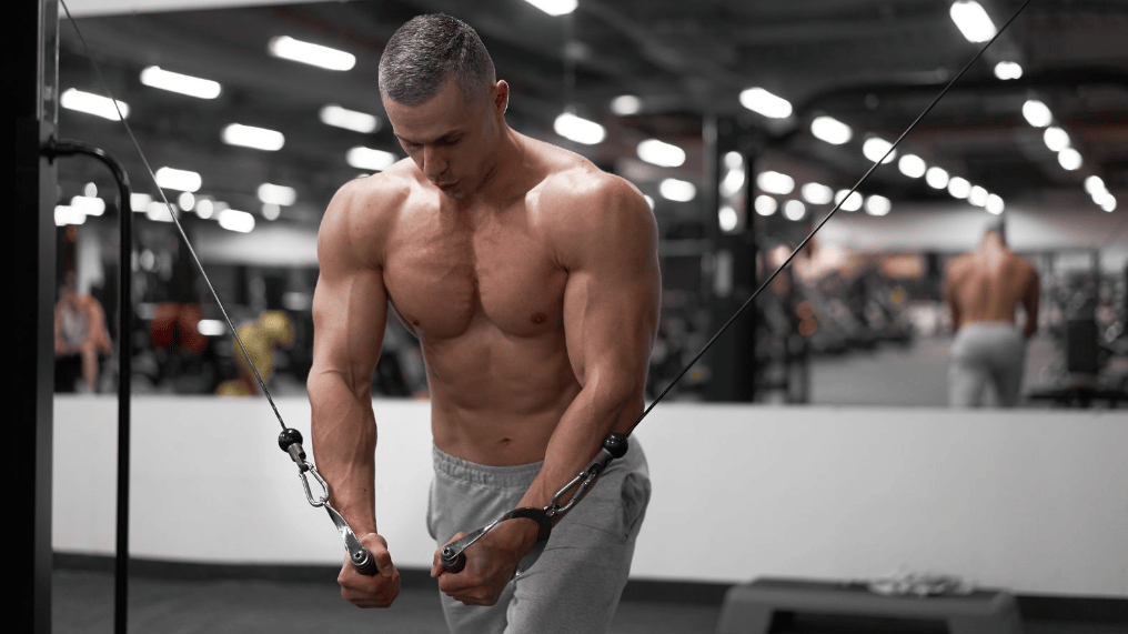 Athlete works chest out with cable machine