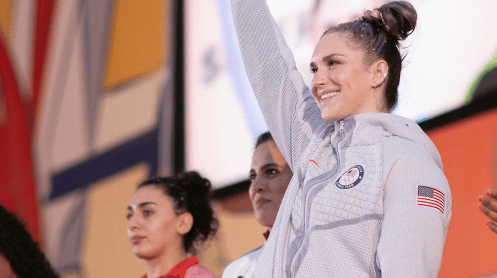 Weightlifter Mattie Rogers celebrating a medal on a podium