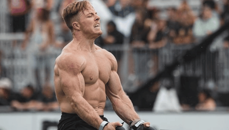 Noah Ohlsen flexing during competition