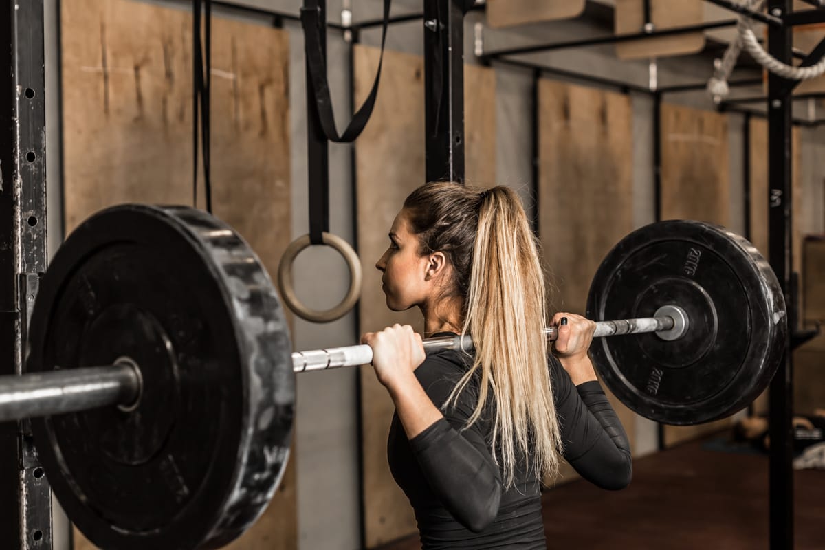 A Women's athlete prepares to squat