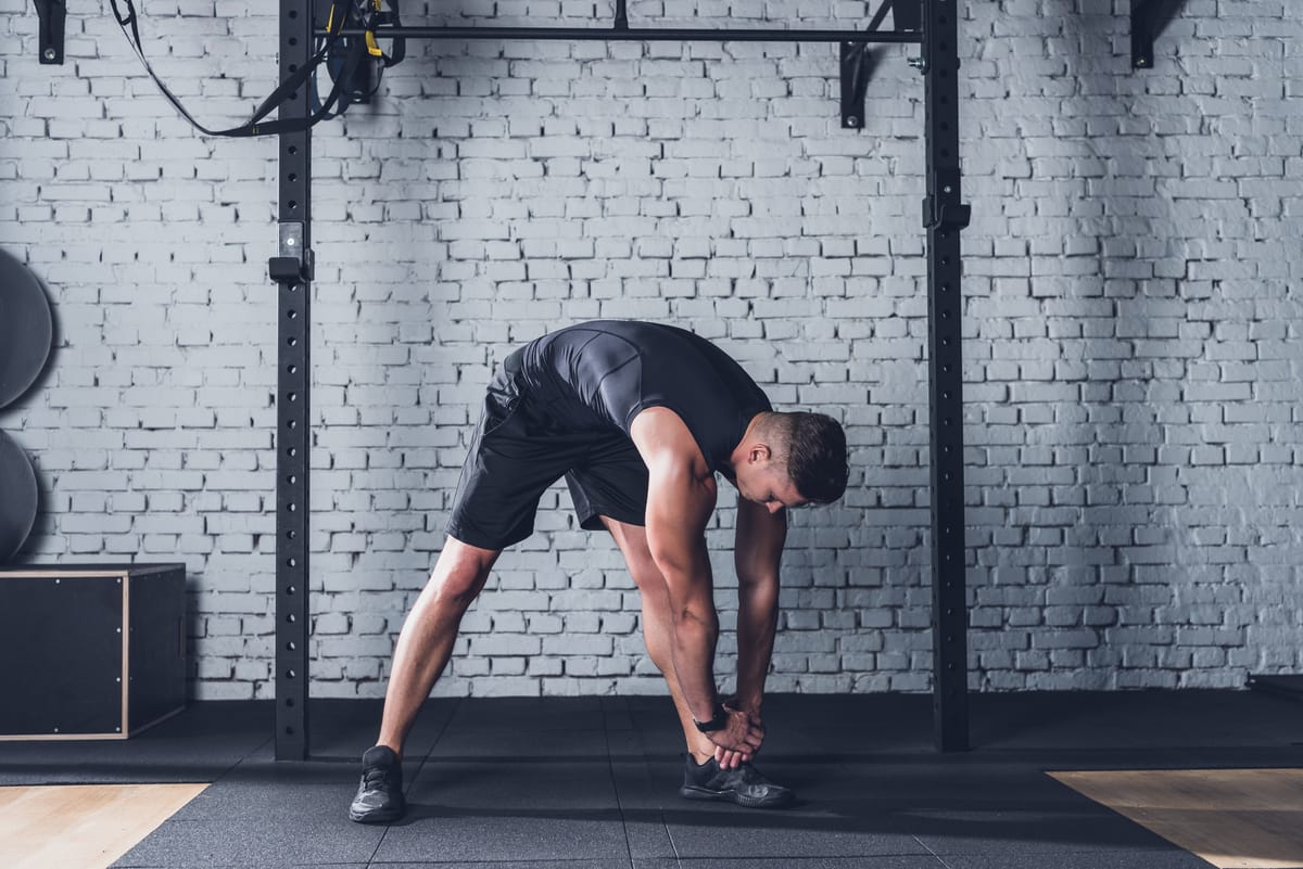 An athlete stretches before his workout