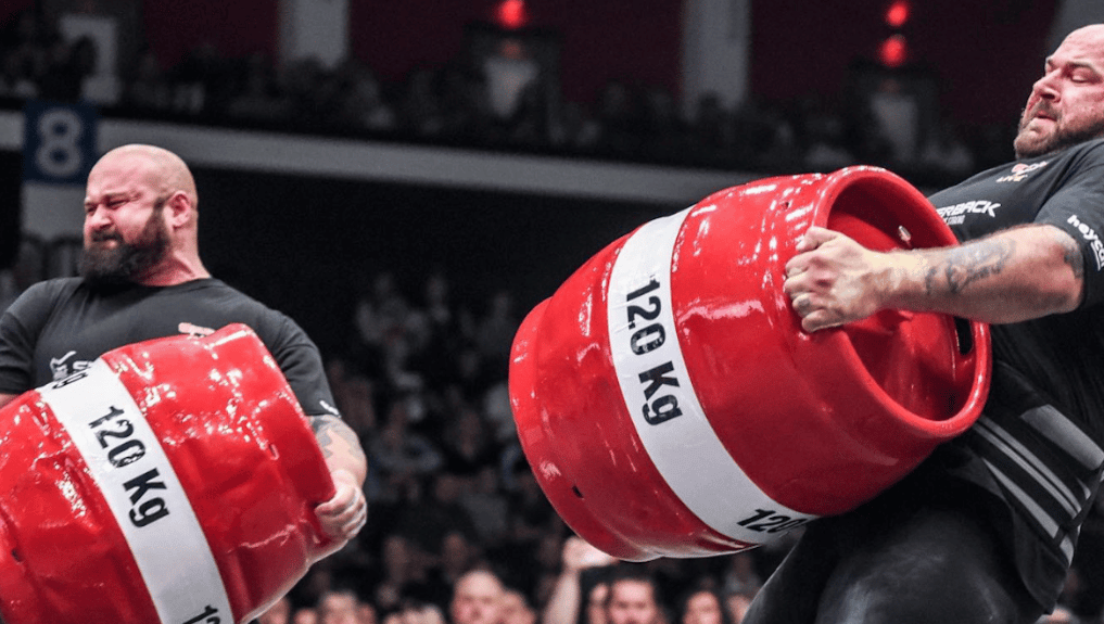 Two athletes carry barrels during the 2021 Giants Live World Tour Finals