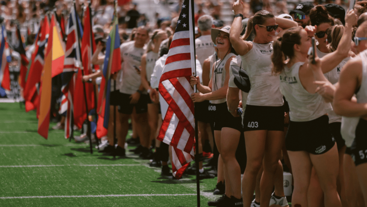Athletes gather with their country's flags during the 2022 CrossFit Games