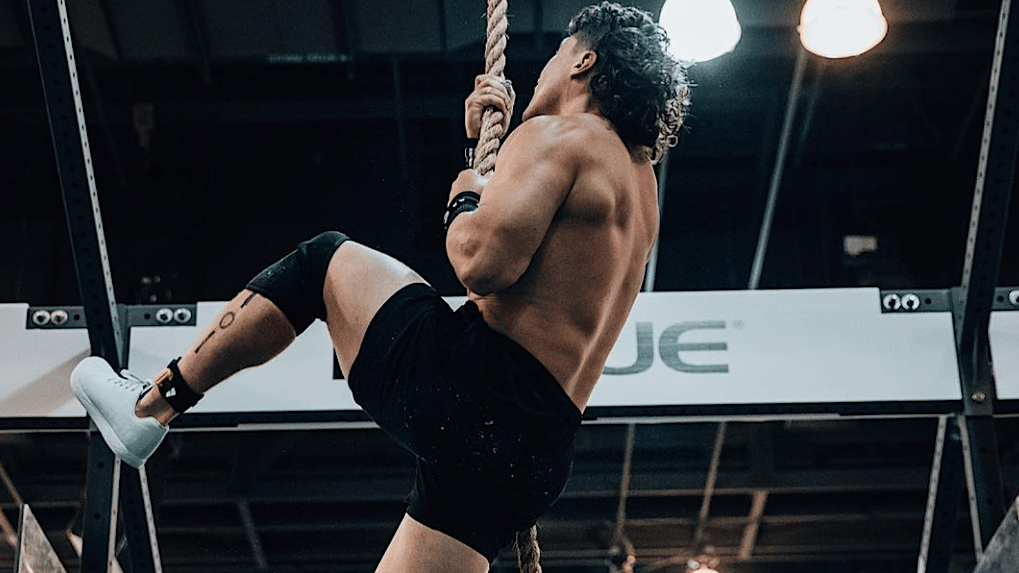 Justin Medeiros climbing a rope