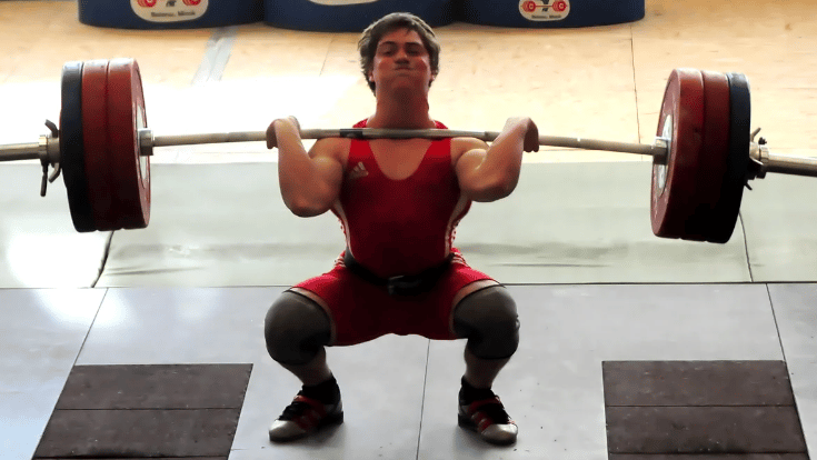 A lifter completes a clean movement