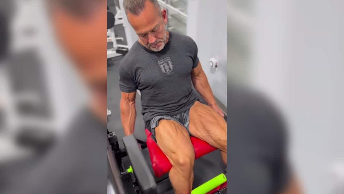 Bodybuilder Lee Labrada performing leg extensions. 
