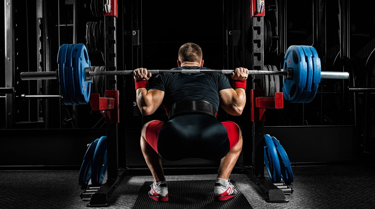 An athlete completes a back squat